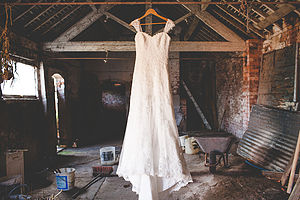 Wedding dress hanging in barn in Staffordshire