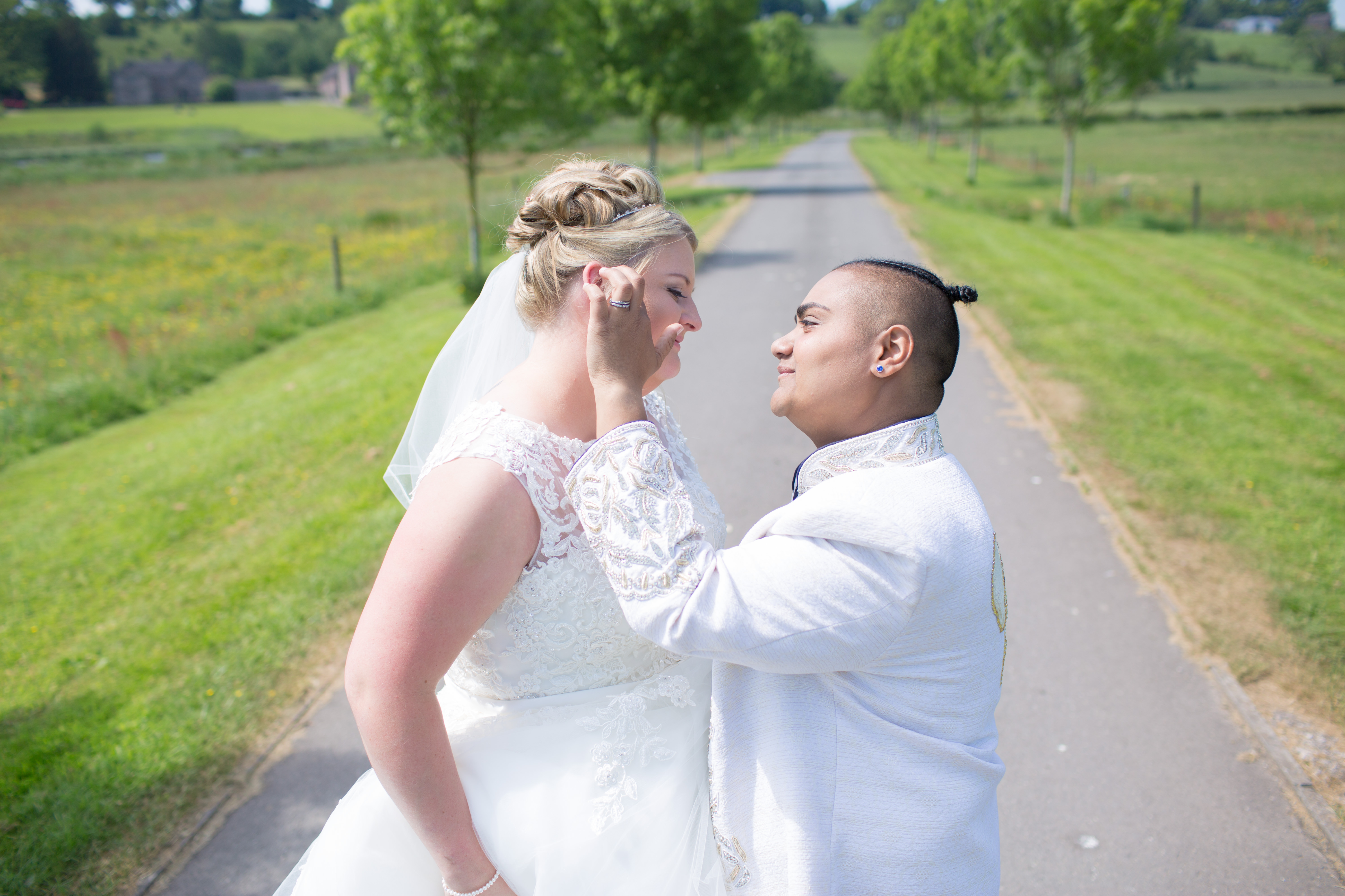 bride touching face of her new wife