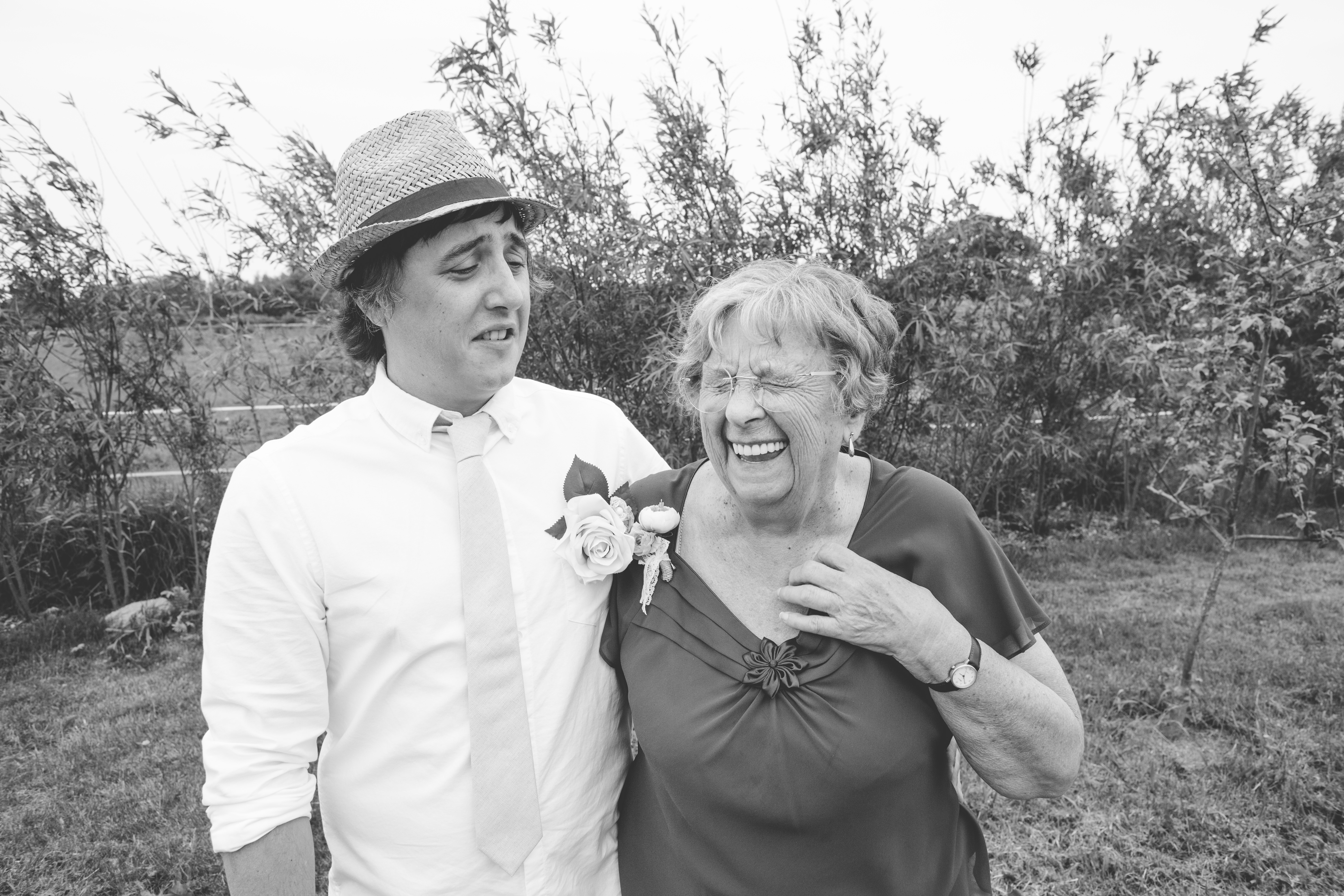 black and white photo of groom with his nan laughing