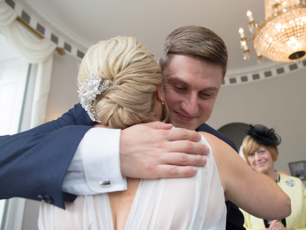 son of bride hugging her