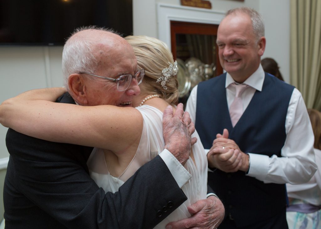 father of bride hugging her