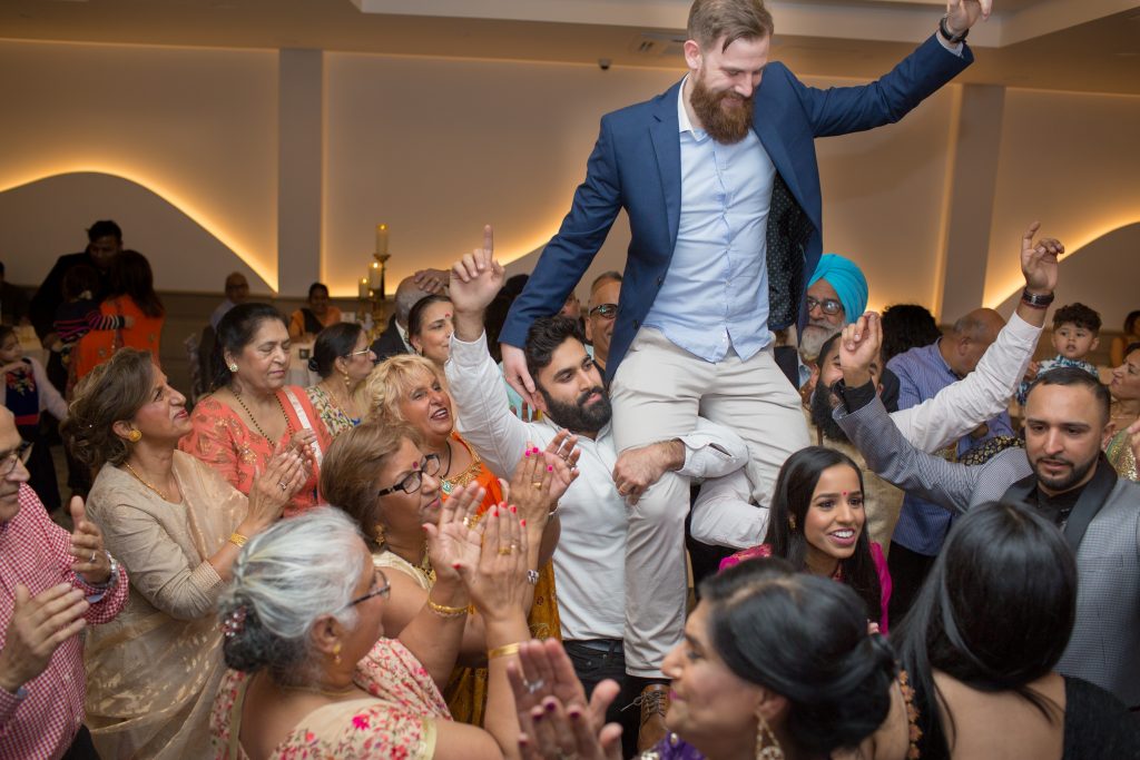 groom being lifted up on shoulders