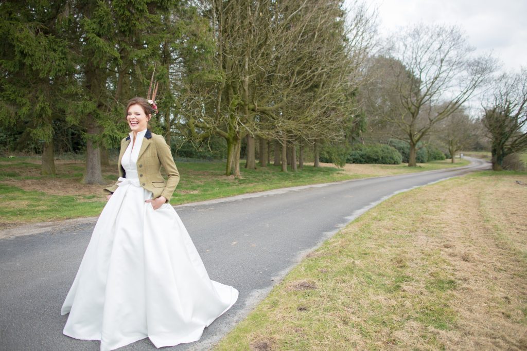 Photo of bride smiling on drive of Standon Hall