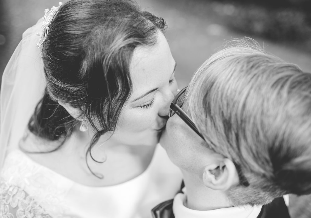 black and white photo of two brides kissing