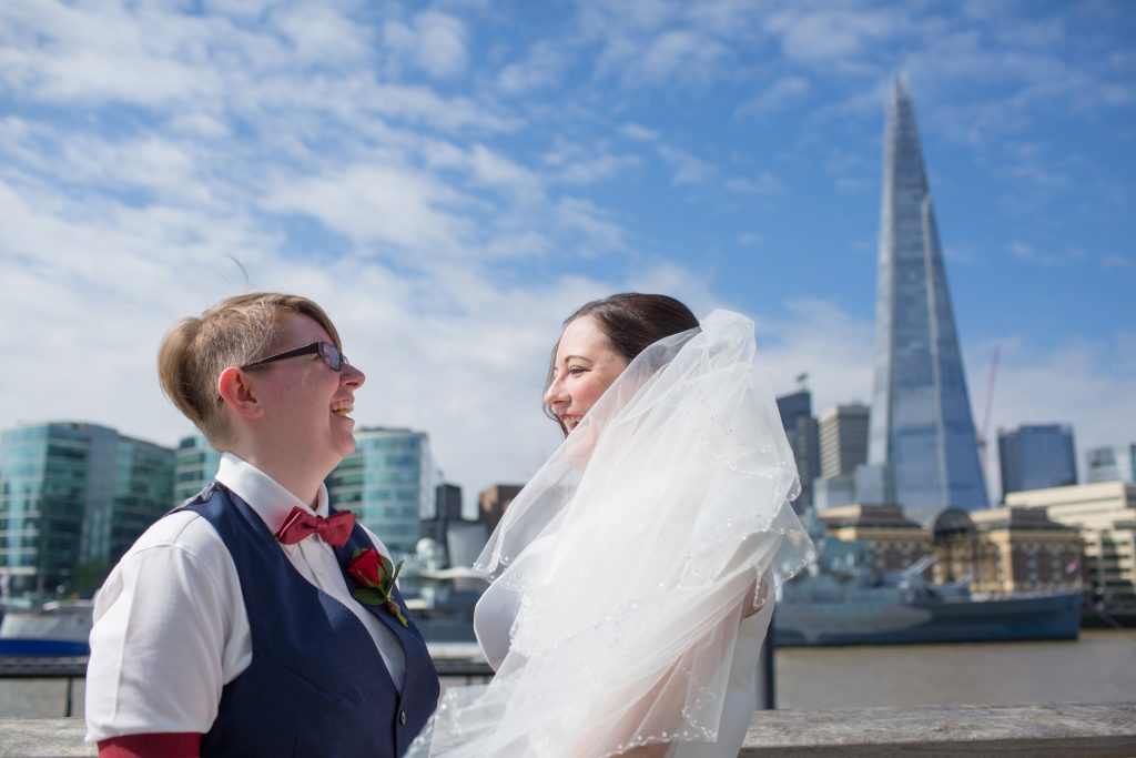 two brides next to the river thames with the shard in the background