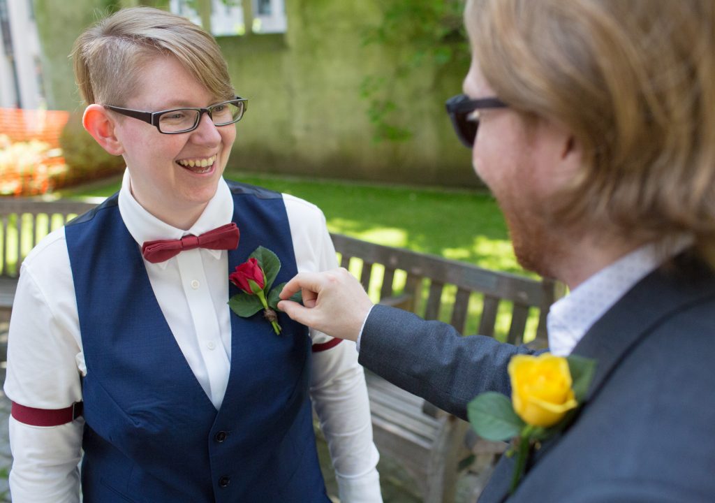 bride having buttonhole checked by best person