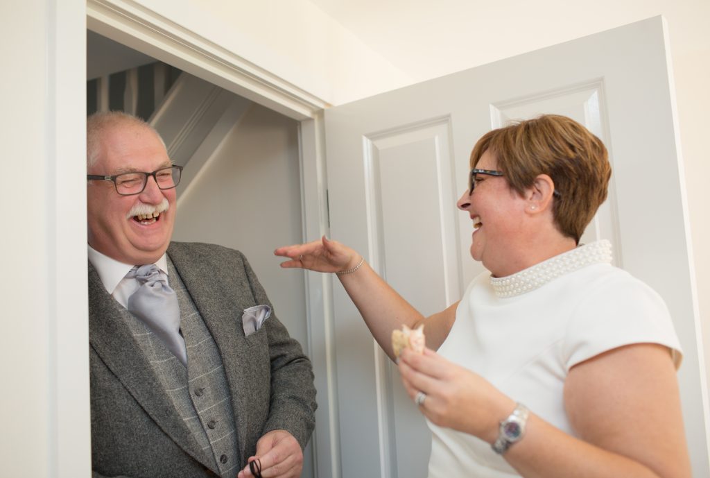 mother and father of the bride laughing