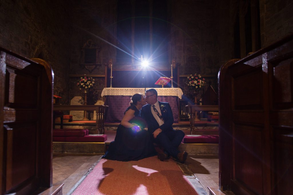 newly married couple kiss inside church