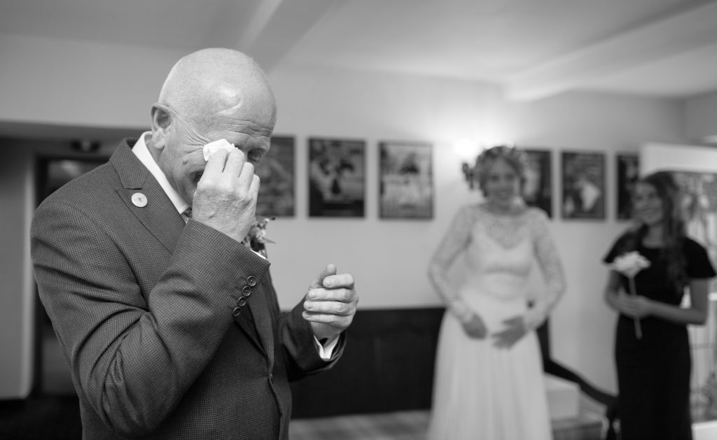 black and white photo of father of bride crying