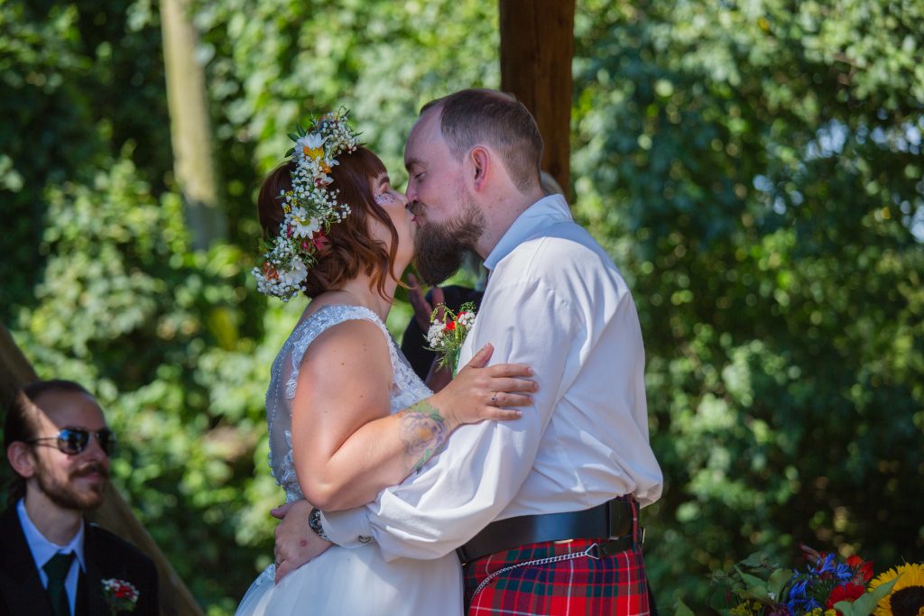 bride and groom kissing after wedding ceremony