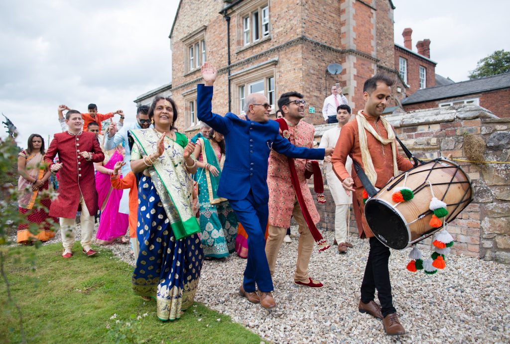 wedding guests walking round to barn at the sweeney hotel