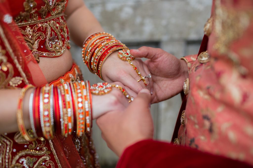 close up photo of bride and groom holding hands