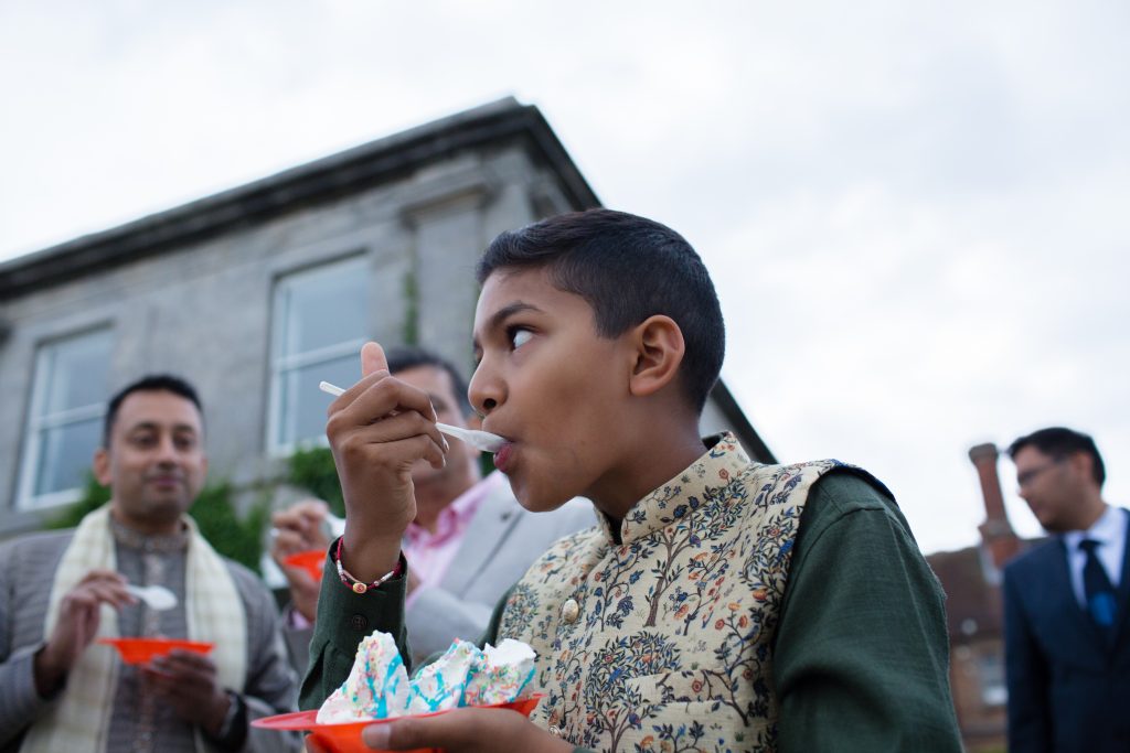 young wedding guest eating icecream