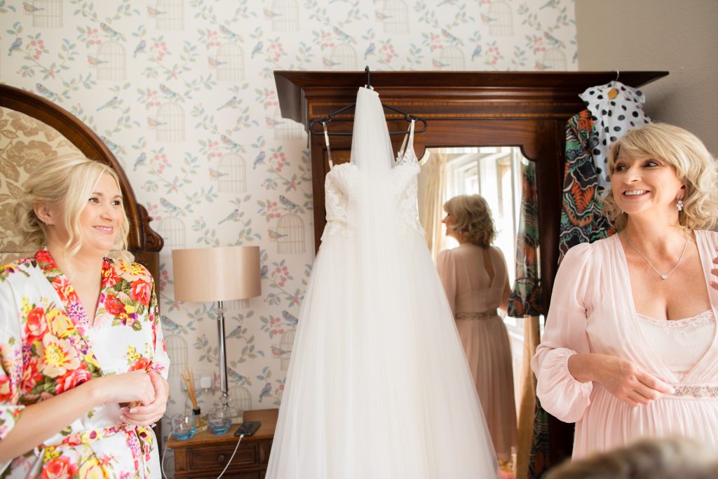 photo of bride with mum and wedding dress