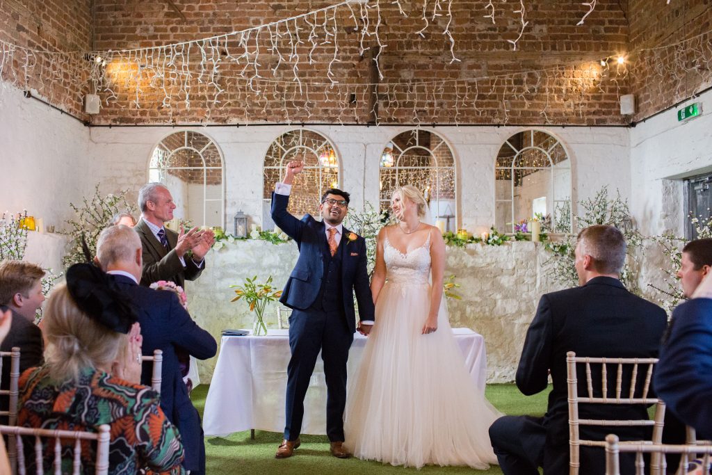 groom punching air after getting married