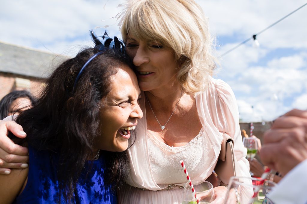 mother of bride and mother of groom laughing