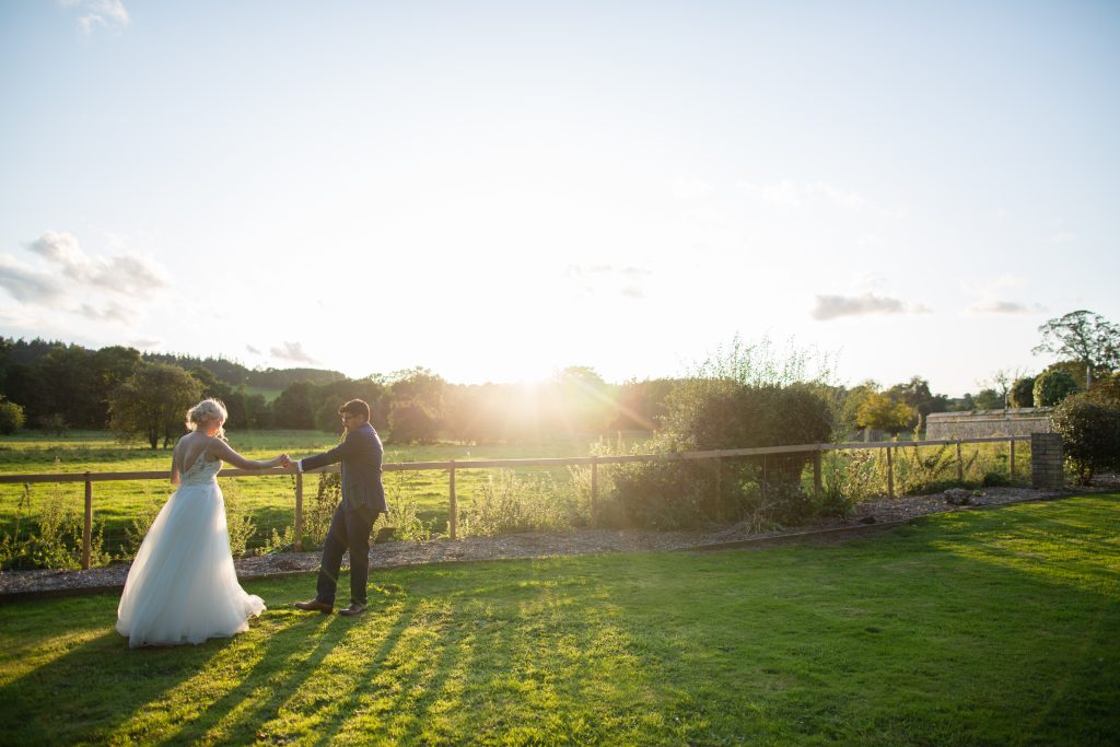 bride and groom practicing first dance outside