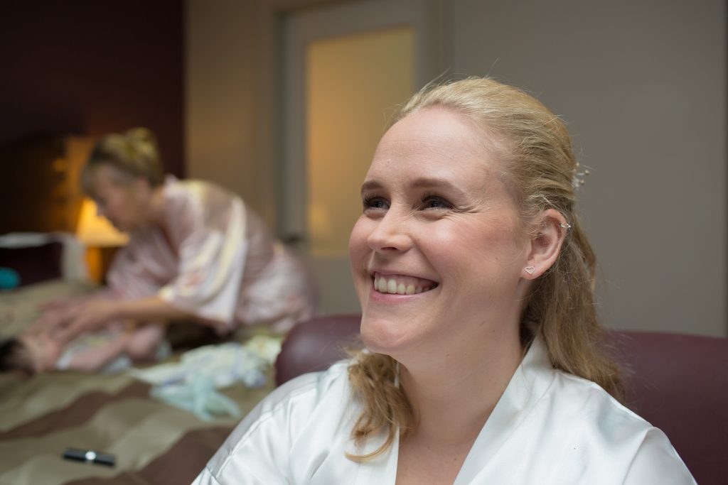 photo of smiling bride during prep