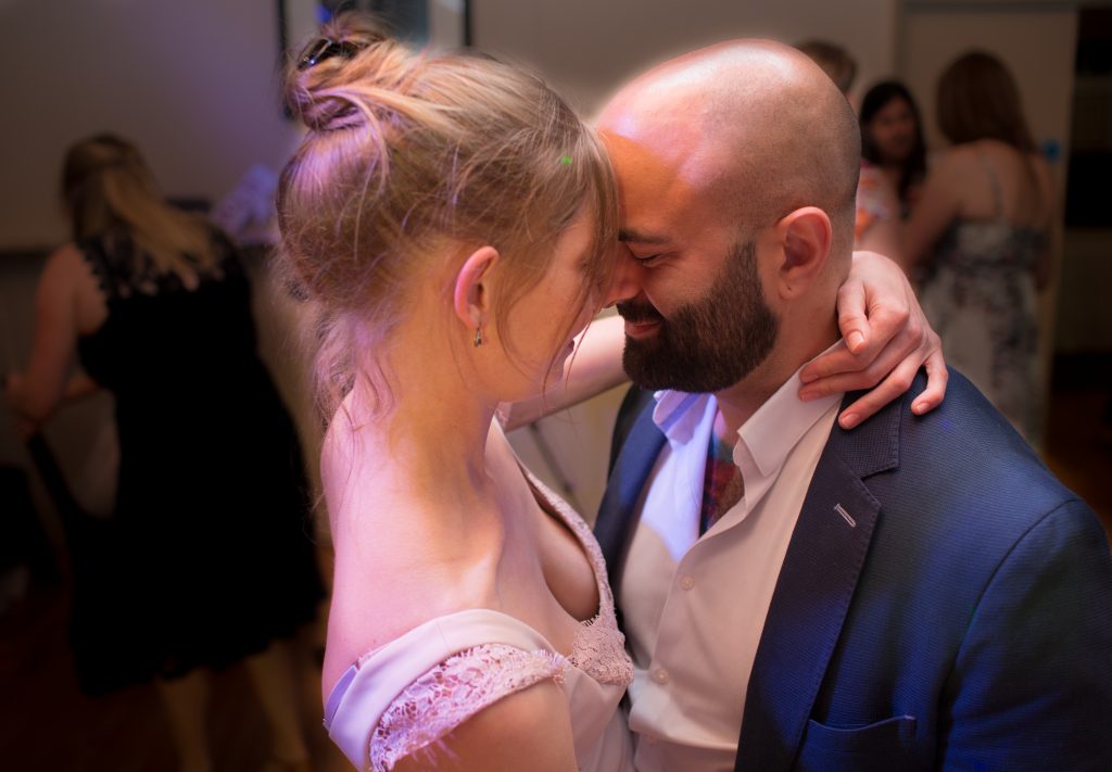 two wedding guests dancing