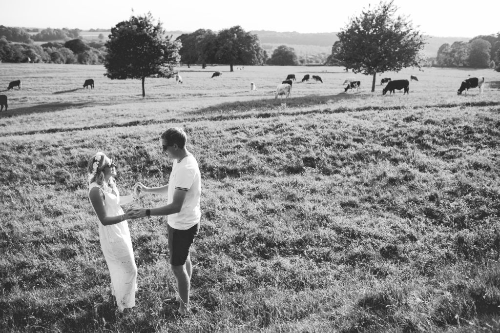 black and white photo of couple in feild