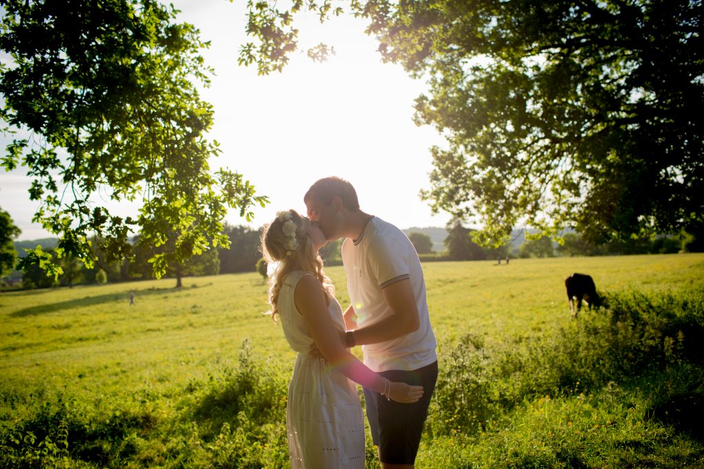 couple kiss under trees