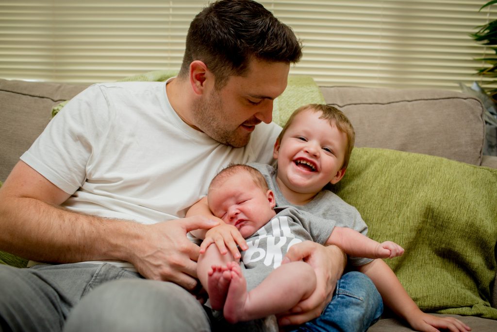 dad with son and newborn