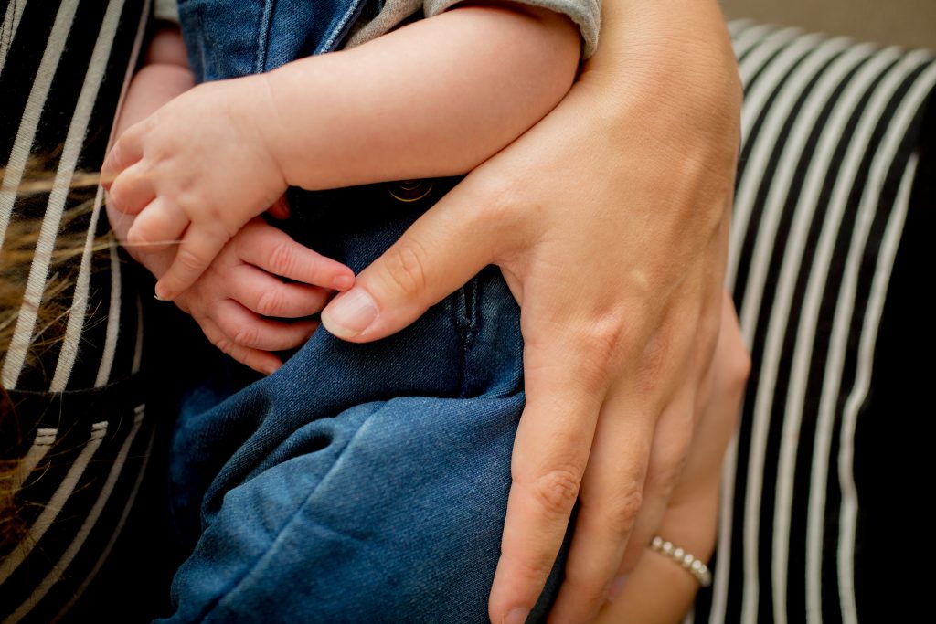 mums protective hand round baby