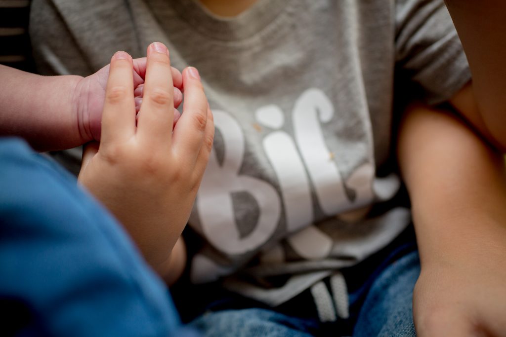 close up photo of children holding hands