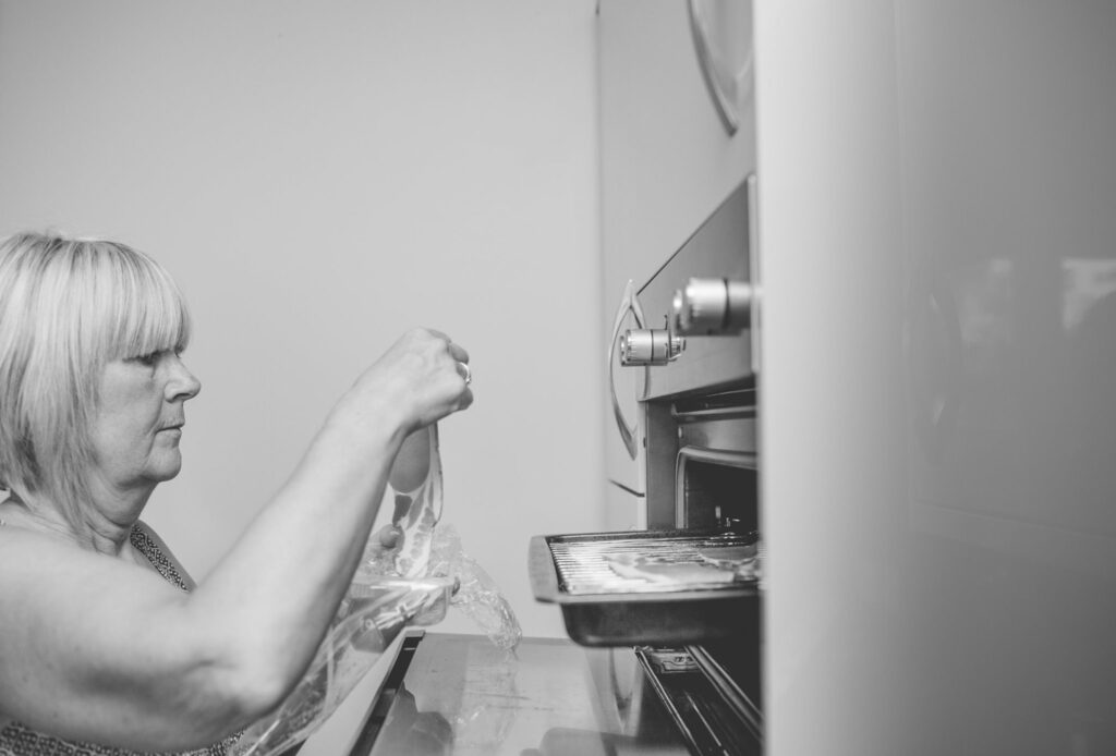 mother of bride cooking bacon on wedding morning