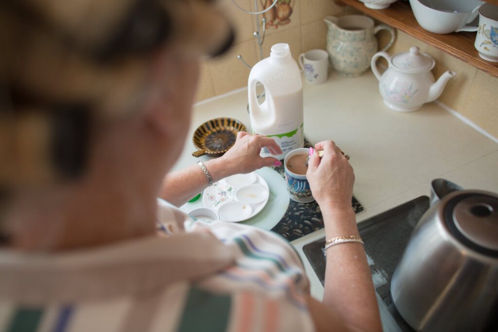 mother of bride making cup of tea on morning of wedding