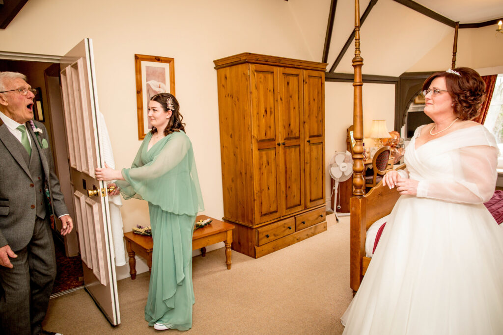 a brides dad reacting to seeing her for the first time in her wedding dress