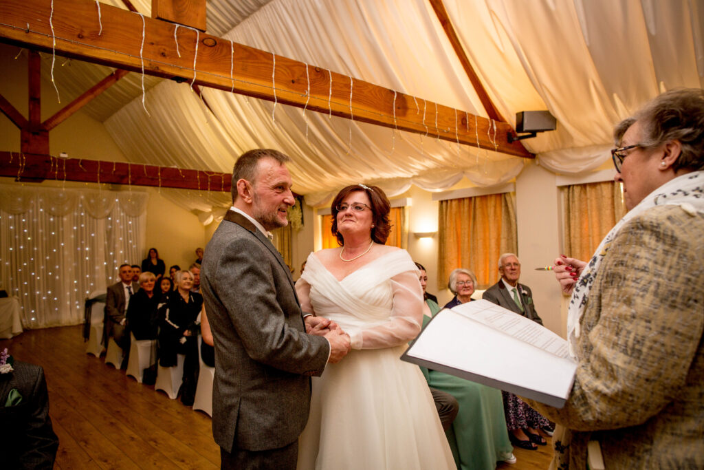 registrar with bride and groom during ceremony