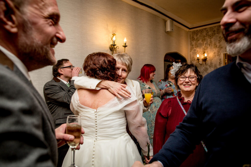 bride being hugged by a wedding guest
