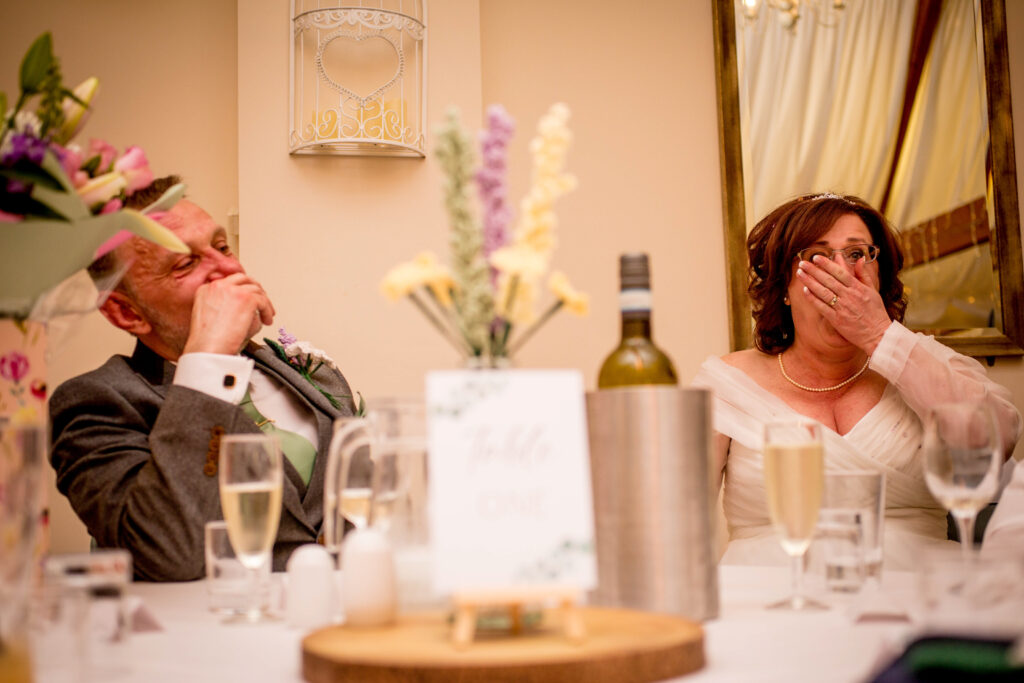 bride and groom laughing at speeches