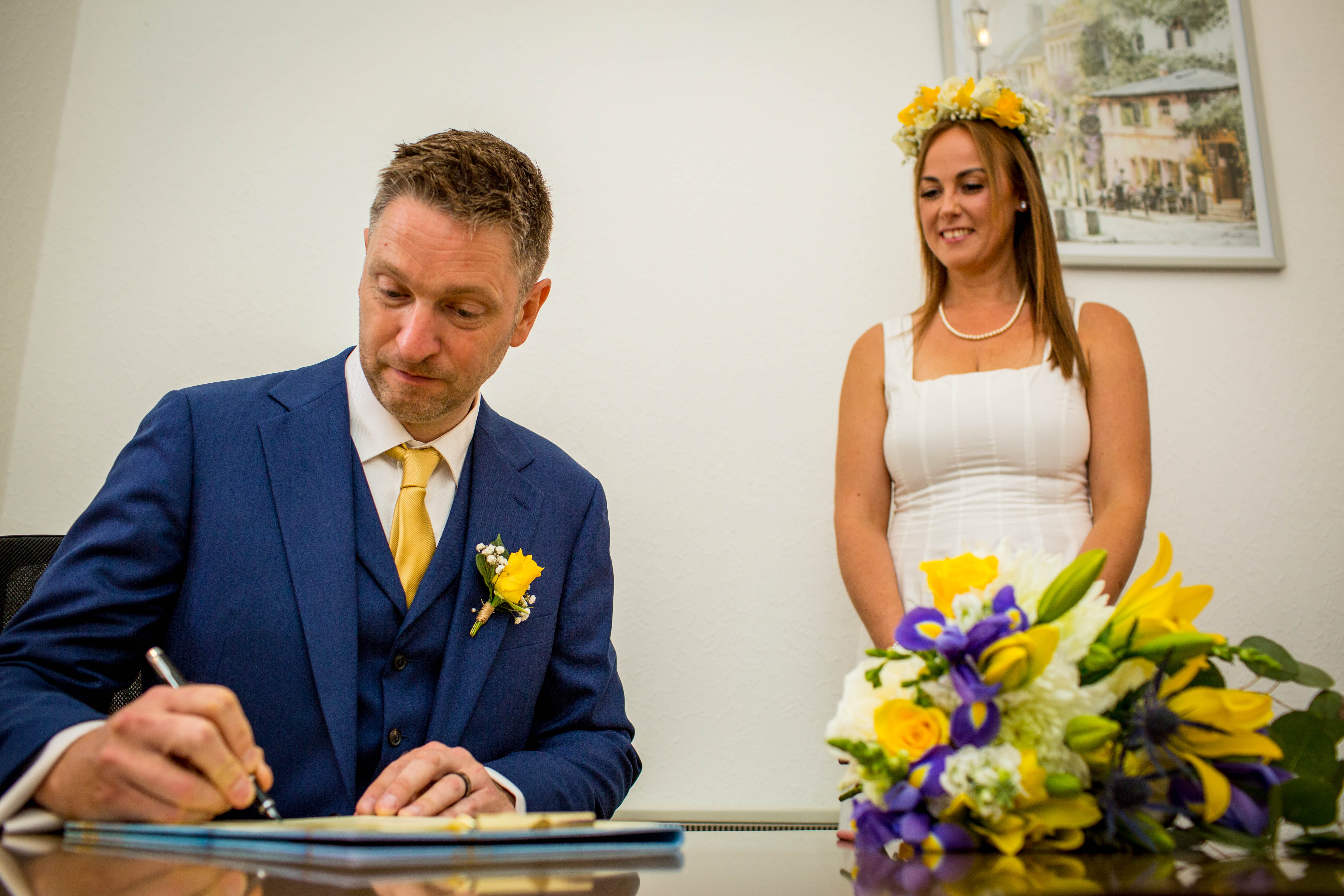 groom signing wedding register