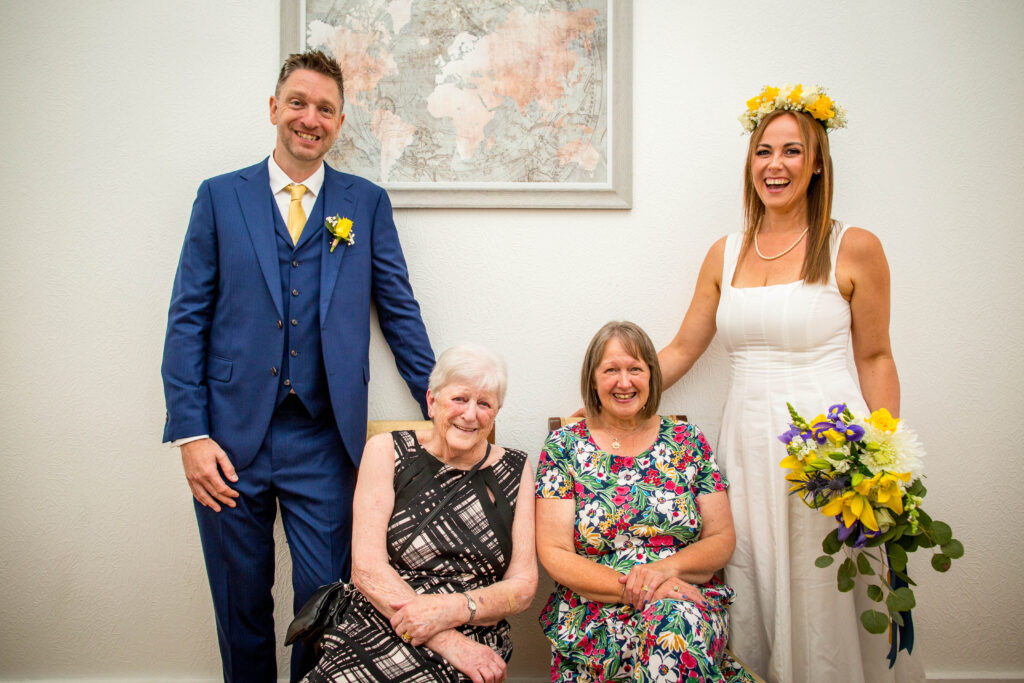 wedding photo of newly married couple with their mums