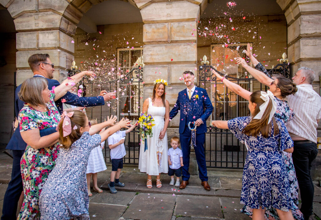 confetti being thrown at newly weds