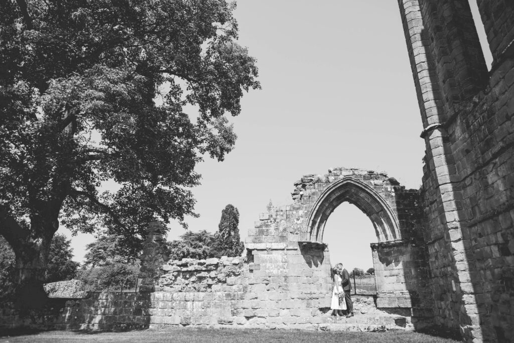 black and white image of bride and groom at croxden abbey