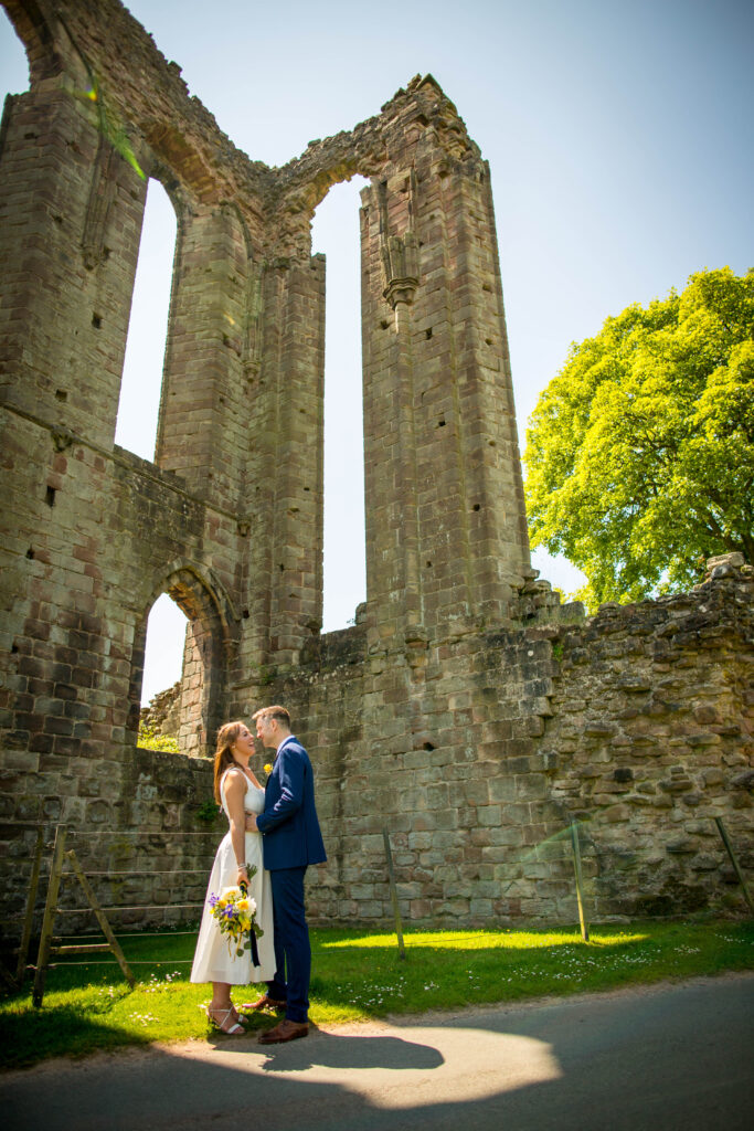 Photo of bride and groom stood in front of croxden abbey