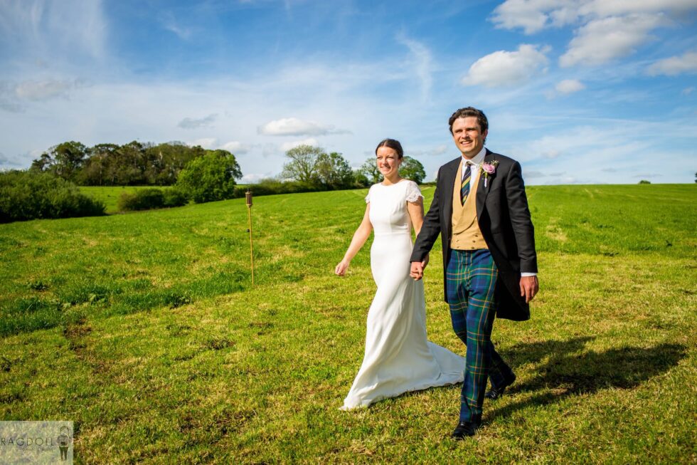 newly married couple walking hand in hand